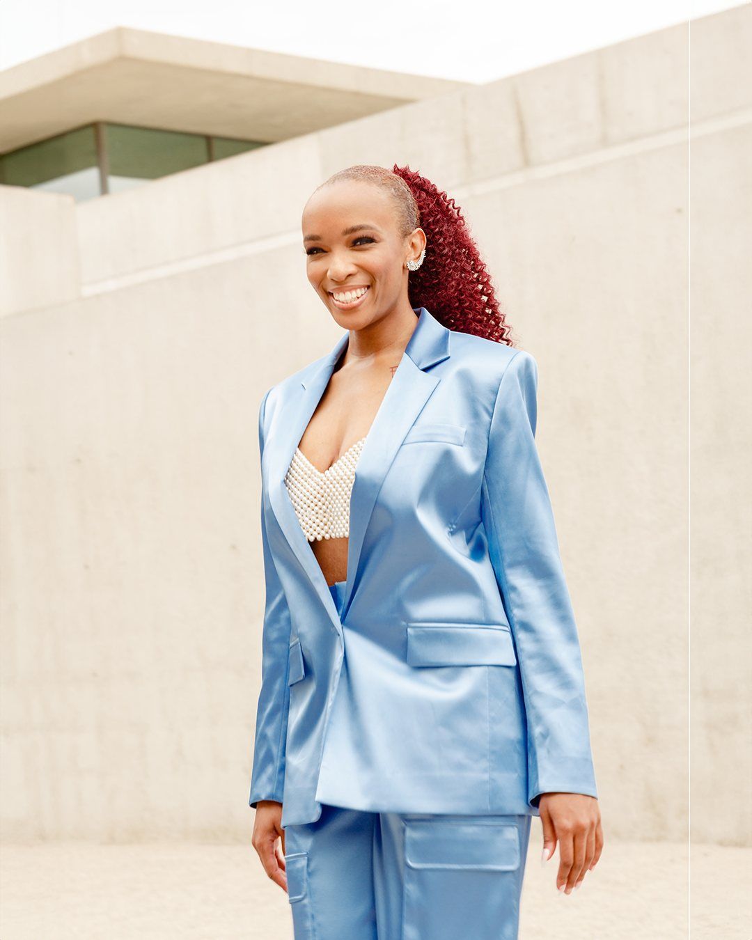 Florie smiling in a satin blue suit