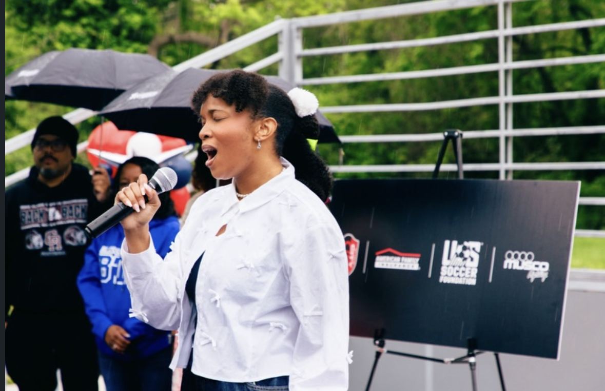Florie singing at the St. Louis CITY SC mini pitch opening