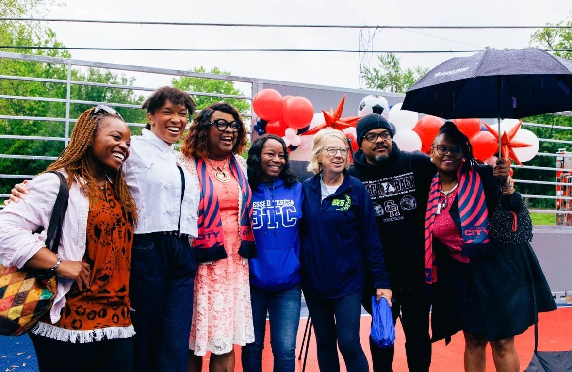 Community partners celebrate the new mini pitch.
