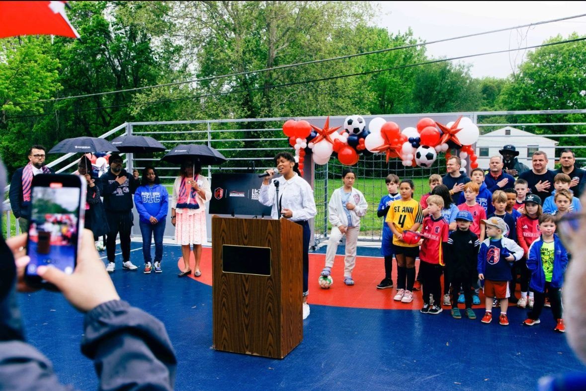 Families and players at the ribbon cutting.