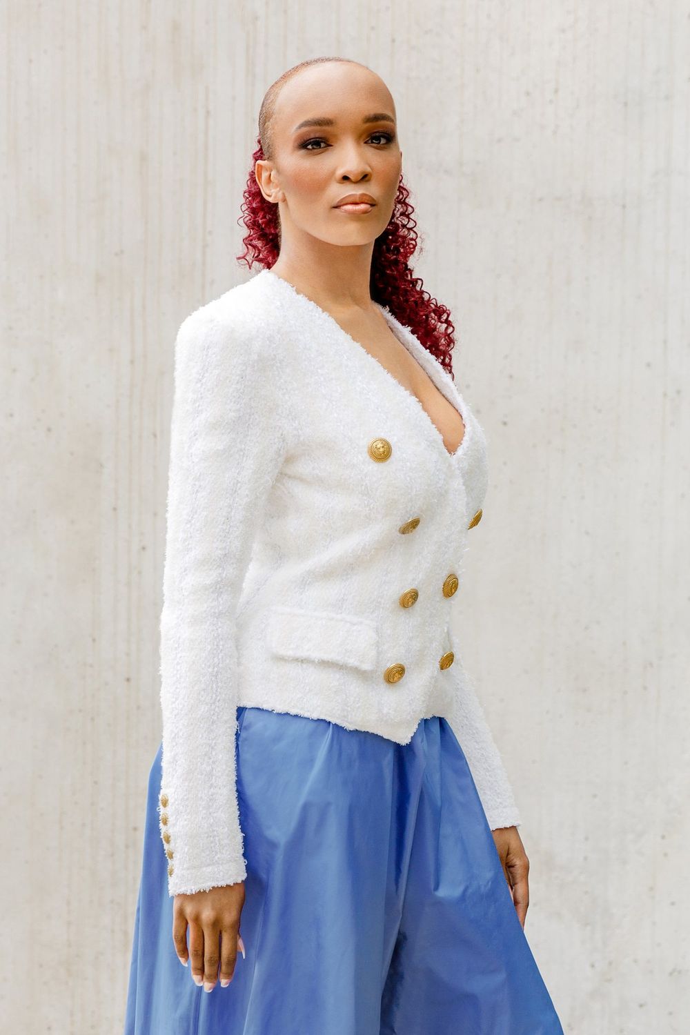 Florie in a white jacket and blue skirt